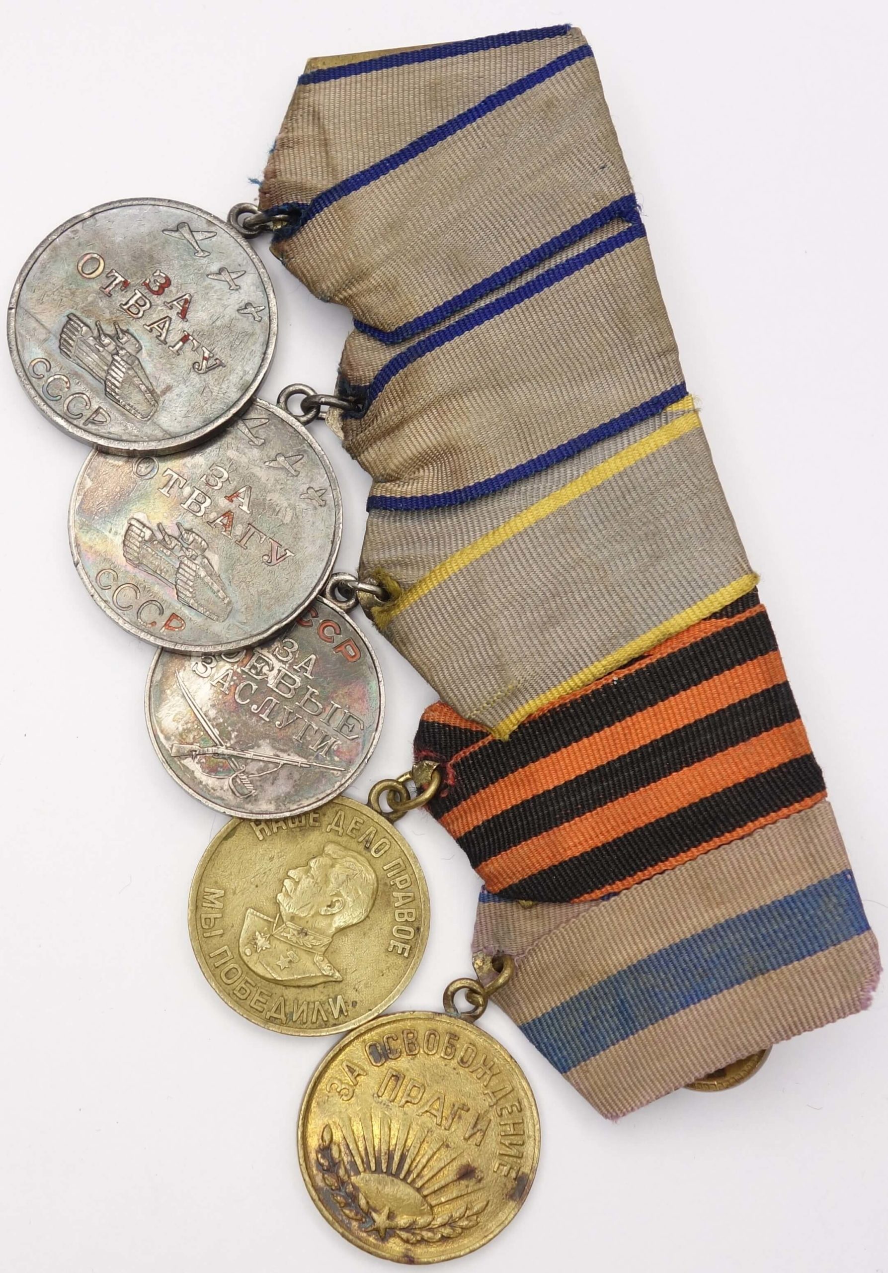 Group of Soviet medals consisting of 2 Medals for Bravery #2435471 & #3299530 + Medals for Combat Merit, Victory over Germany and Liberation of Prague