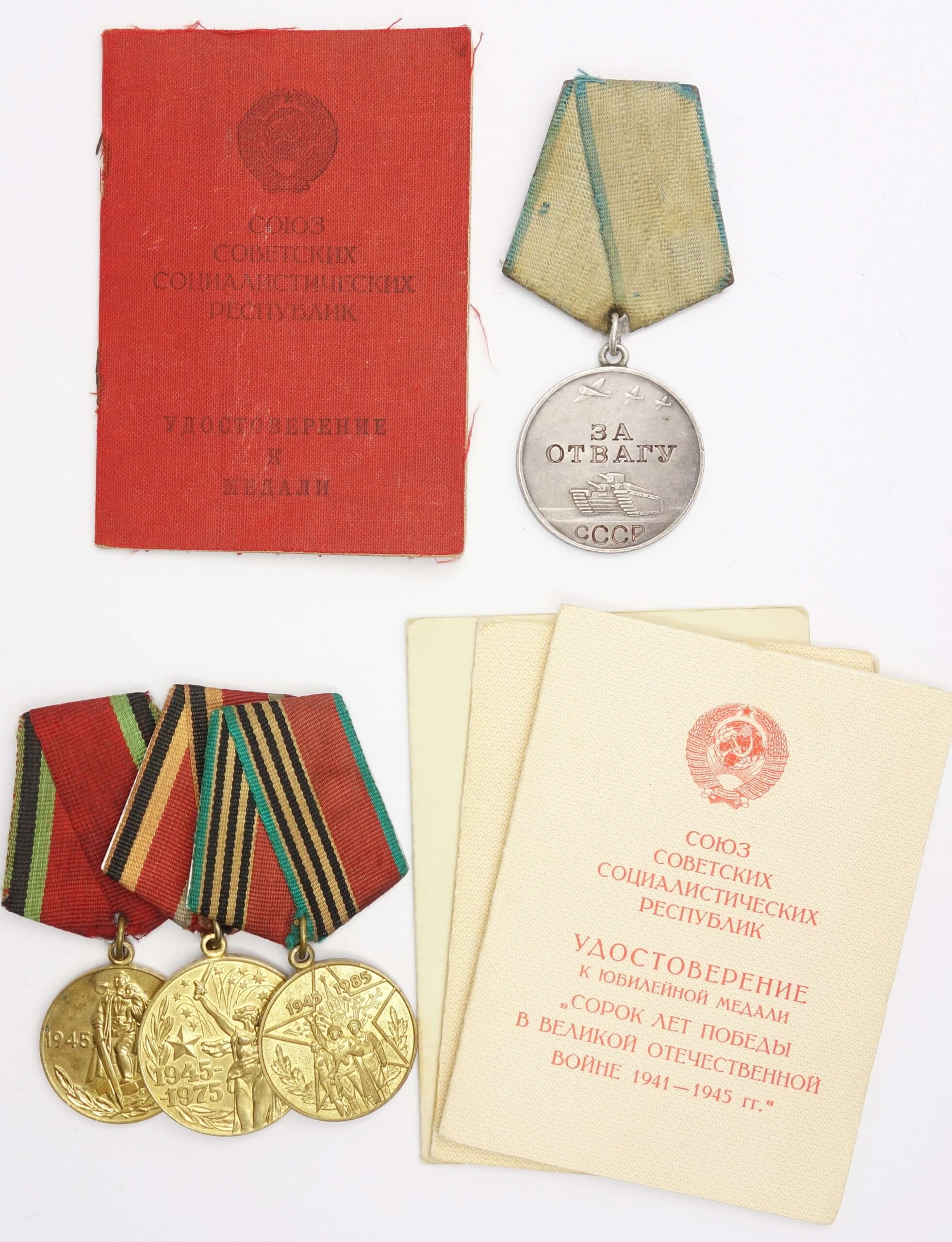 Group of Soviet medals consisting of a Medal for Bravery #816481 & three Jubilee Medals + award booklets