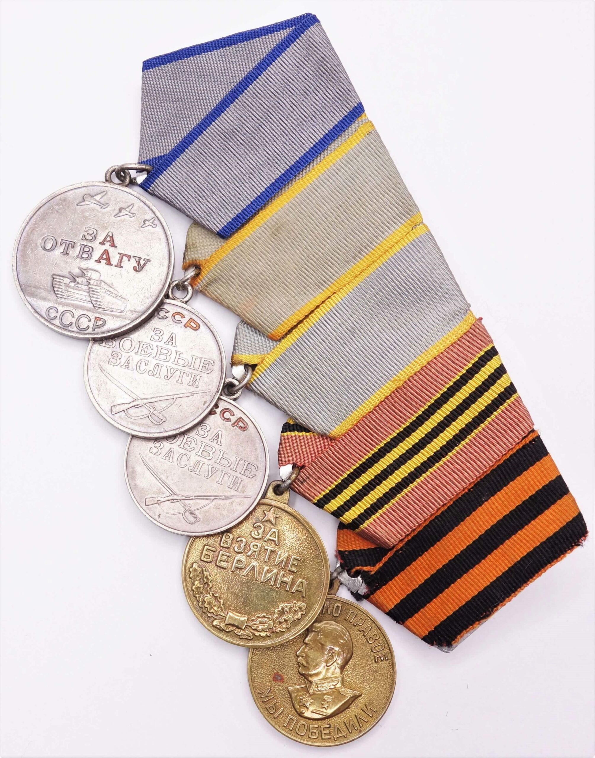 Group of Soviet medals consisting of a Medal for Bravery #2335421 + Medals for Combat Merit #2820082, Berlin and Victory over Germany