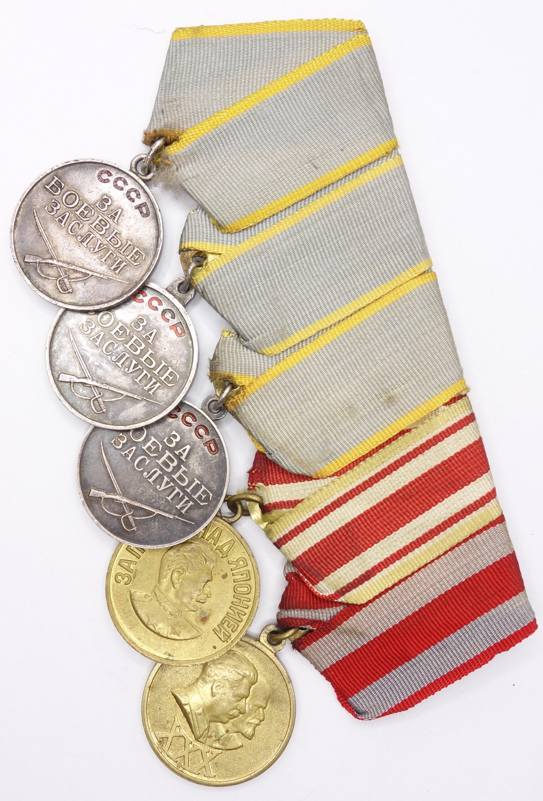 Group of Soviet medals consisting of 3 medals for Combat Merit, Medal for the Victory over Japan and a 30 years Red Army medal