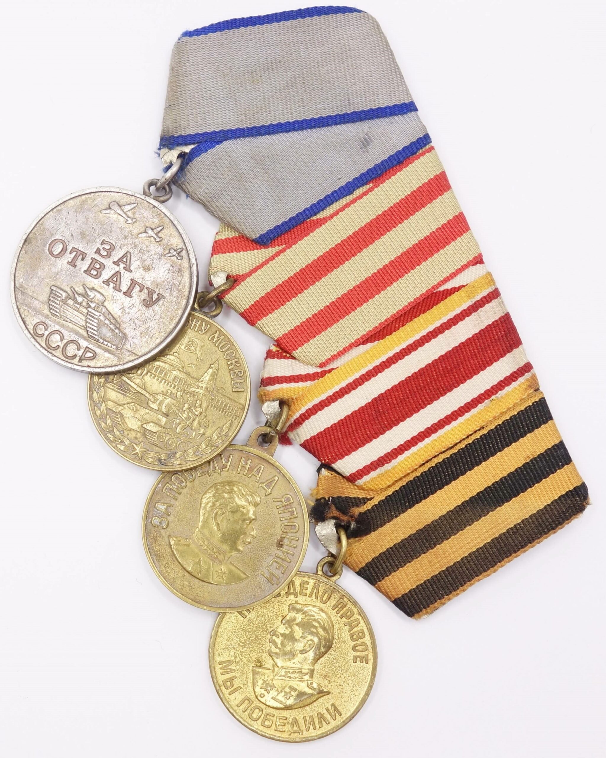 Group of Soviet medals consisting of a Medal for Bravery #2610434 and Medals for Moscow, Japan and Germany